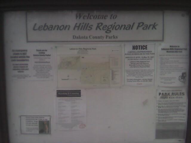 A welcome sign at Lebanon Hills Regional Park, featuring a map of the park and various notices and rules about park use, under the banner "Welcome to Lebanon Hills Regional Park, Dakota County Parks." Lebanon Hills mountain bike trail.