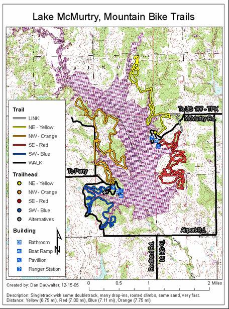 Map of Lake McMurtry Mountain Bike Trails, featuring various colored trails indicating different routes. The map outlines trailheads, distances, and nearby facilities such as bathrooms and a boat ramp. Key includes trail difficulty and type, with a scale indicating distances up to 2 miles. McMurtry Trail mountain bike trail.