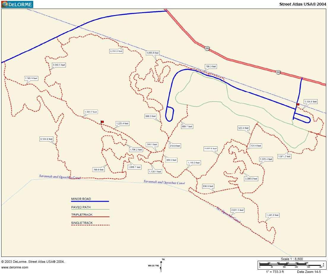 Map showing various roads and paths, including minor roads, paved paths, triple tracks, and single tracks, with key distances labeled. The layout is overlaid on a light background, distinguishing different routes and their measurements for navigation purposes. Tom Triplet mountain bike trail.
