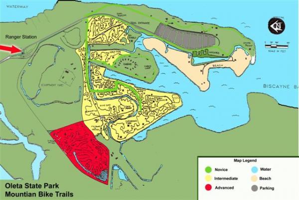Map of Oleta State Park showing mountain bike trails, with designated areas for novice (green), intermediate (yellow), and advanced (red) trails. Includes key features like the ranger station, parking, beach access, and nearby waterways. Oleta River State Park mountain bike trail.