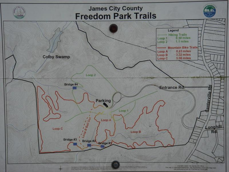 Map of Freedom Park Trails in James City County, showing various hiking and mountain bike trails. The map includes labeled loops, bridges, parking areas, and notable landmarks such as Colby Swamp and Entrance Road, with distances indicated for each trail. Freedom Park (aka:district Park) mountain bike trail.