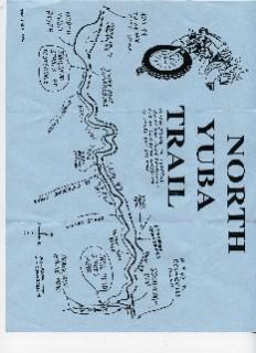A blue map titled "North Yuba Trail" featuring various trails, pathways, and notable landmarks. The map includes labeled points of interest, elevation changes, and geographic features along the trail, presented in a hand-drawn style. North Yuba mountain bike trail.