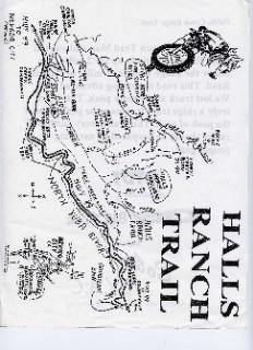 A hand-drawn map of Halls Ranch Trail, depicting various trails, landmarks, and terrain features. The map includes labeled routes and notes, with a decorative illustration of a dirt bike rider in the corner. Text is prominently displayed at the top reading "HALLS RANCH TRAIL." Fiddle Creek mountain bike trail.