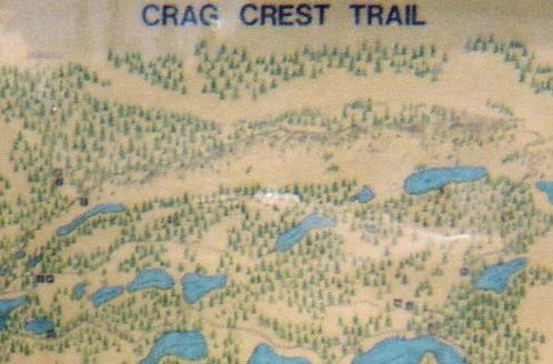 Map of the Crag Crest Trail, featuring a topographical illustration with lakes, wooded areas, and trails marked. Lower Crags Crest Trail mountain bike trail.