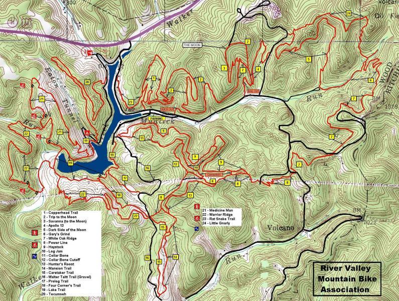A detailed topographic map of a mountain biking trail system, featuring various trails marked in red and numbered for reference. The map includes a lake and surrounding terrain, with contour lines indicating elevation changes. A legend at the bottom lists trail names and their respective numbers, representing different biking paths. The map is labeled with "River Valley Mountain Bike Association." Mountwood mountain bike trail.