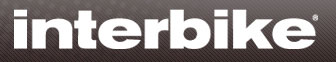Logo of Interbike, a trade show for the bicycle industry, featuring the word "interbike" in bold, white letters on a dark textured background.