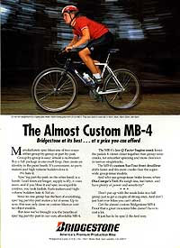 A magazine advertisement showcasing the Bridgestone Almost Custom MB-4 bicycle. The image features a cyclist wearing a red shirt and helmet, riding on a wooded path. The ad includes text promoting the bike’s quality and affordability, alongside the Bridgestone logo.