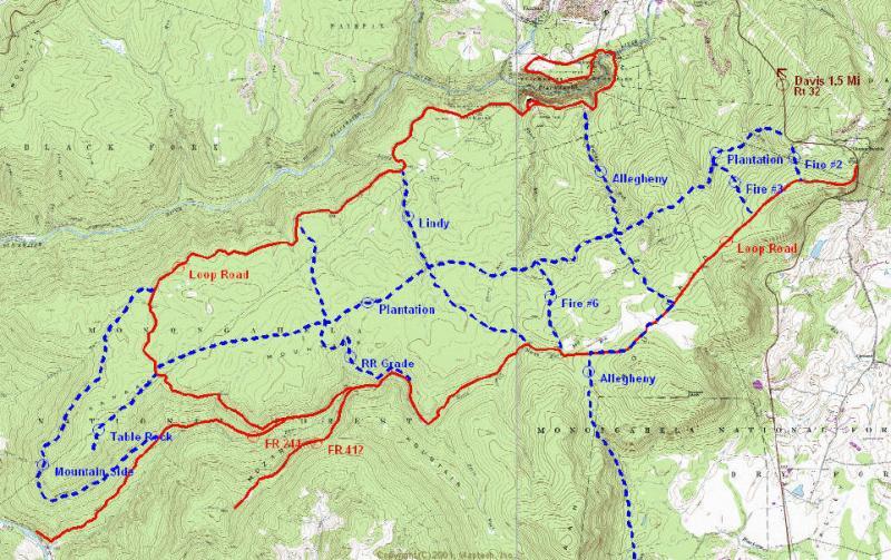 Map showing a detailed topographic layout with various trails and roads, marked in red and blue, including Loop Road, Plantation, and fire routes, set in a mountainous area with contour lines indicating elevation changes. Plantation Trail mountain bike trail.