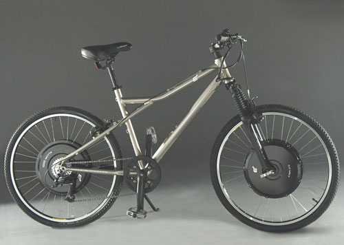 Silver mountain bike with thick tires and front suspension, positioned against a dark background.