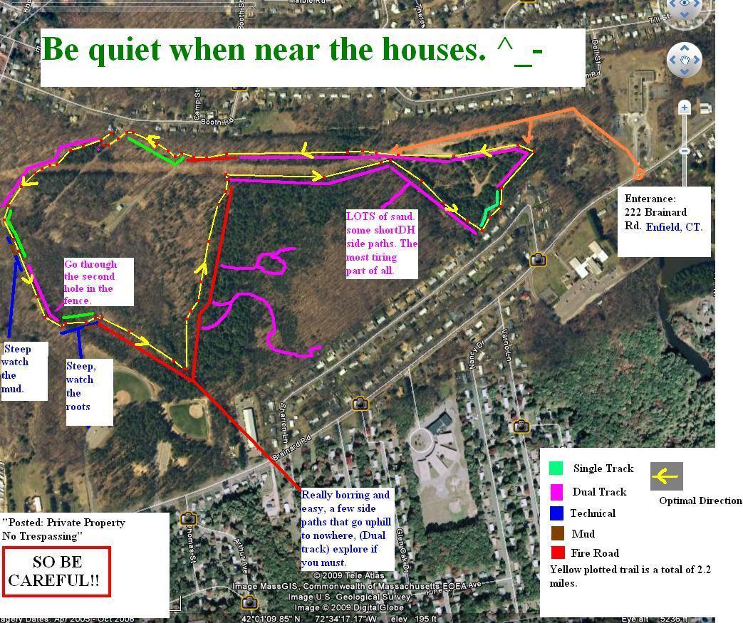 A map of a wooded area in Enfield, CT, showing various bike trails with color-coded paths indicating different types of terrain, such as single track and dual track. There are notes cautioning about steep sections, sandy areas, and a reminder to be quiet near houses. The map also includes an entrance location and warnings about private property and safety. Water Company Owned Woods mountain bike trail.