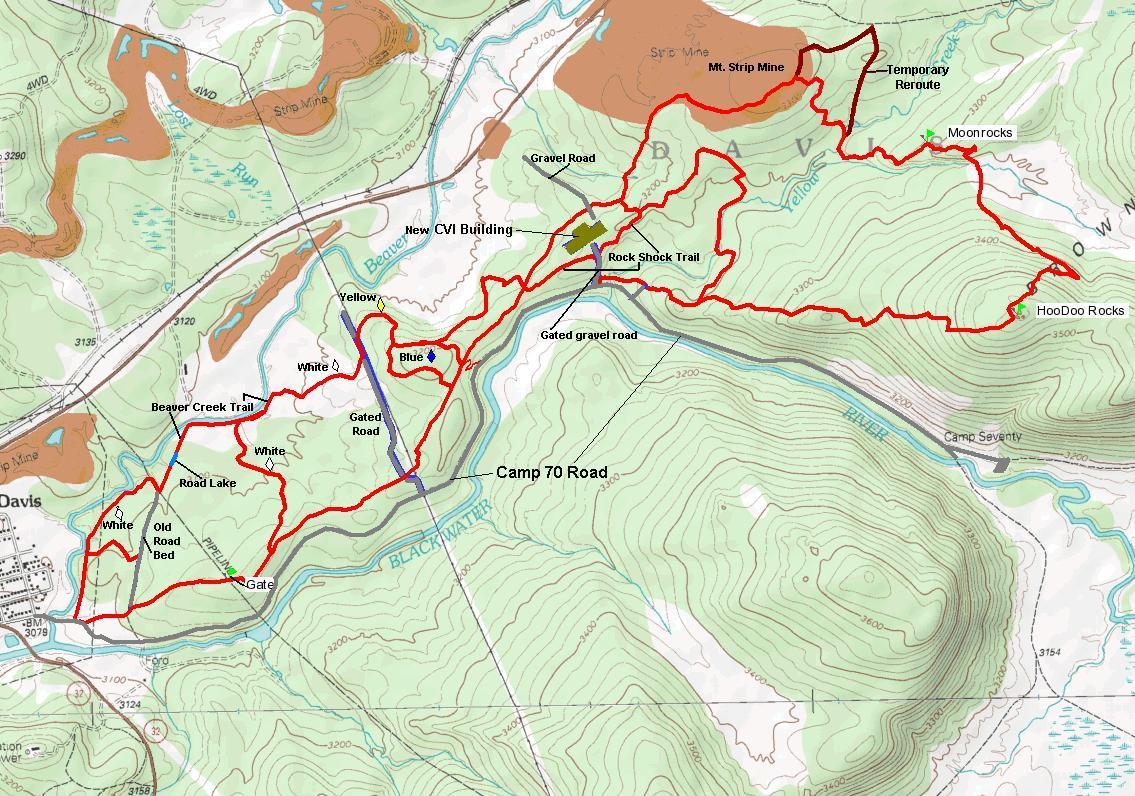 A topographic map displaying various trails and landmarks in a mountainous area. Key features include marked trails in red, such as the Beaver Creek Trail and Rock Shock Trail, along with bodies of water like Road Lake and Blue. The map also indicates roads, including Camp 70 Road, and other points of interest like the Mt. Strip Mine and HooDoo Rocks. Contours show elevation changes across the terrain. CVI Trails mountain bike trail.