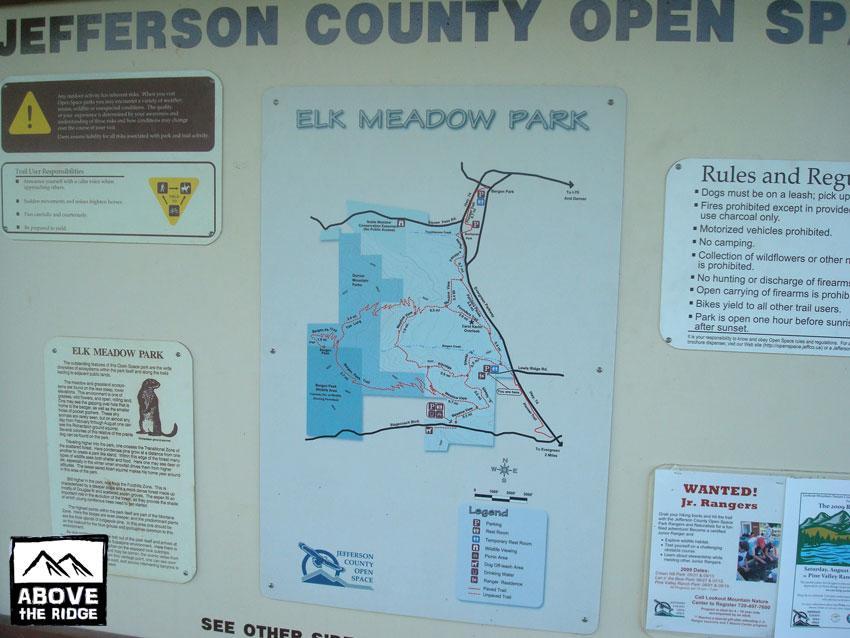 Map of Elk Meadow Park displayed on a notice board at Jefferson County Open Space, featuring park rules, trail information, and details about park regulations, including restrictions on dogs, fires, and camping. Elk Meadow mountain bike trail.
