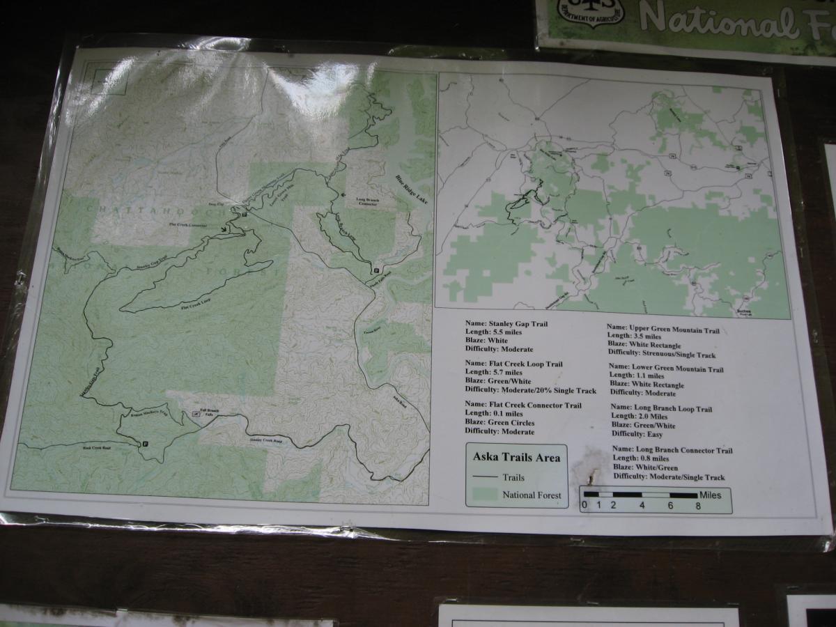 Map of hiking trails in the Aska Trails Area, featuring various marked trails with details including trail names, lengths, blazes, and difficulty levels. The map outlines the surrounding national forest and includes depictions of the terrain. Stanley Gap mountain bike trail.