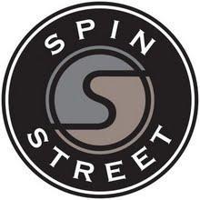 Logo for Spin Street, featuring a circular design with a stylized "S" in the center, surrounded by the text "SPIN" at the top and "STREET" at the bottom, all set against a black background.