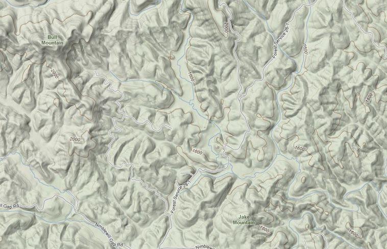Detailed topographic map showing mountainous terrain with elevation contours. Notable features include Bull Mountain and Jake Mountain, along with various elevation markers and winding roads throughout the landscape. Bull / Jake Mountain mountain bike trail.