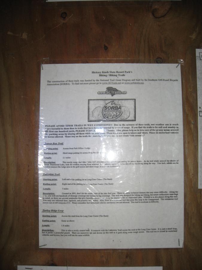 A bulletin board notice for Hickory Knob State Resort Park, detailing the park's biking and hiking trails. The document includes information on trail construction, conditions to avoid during wet weather, and descriptions of three specific trails: Horse Run Trail, Lakeview Trail, and Turkey Ridge Loop, including starting points, lengths, and difficulty levels. Hickory Knob State Park mountain bike trail.