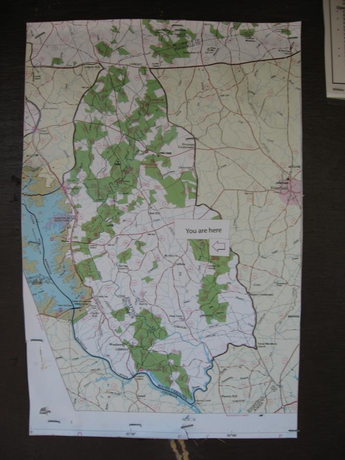 A map displaying various geographical features, including green shaded areas indicating parks or nature reserves. The map includes labeled roads and a marked location indicating "You are here" with an arrow pointing to it. Lick Fork (Horn Creek) mountain bike trail.