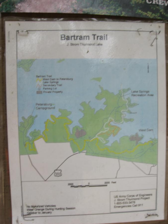 Map of the Bartram Trail at J. Strom Thurmond Lake, displaying various trails, parking lots, and notable areas such as Petersburg Campground and Lake Springs Recreation Area. The map includes warnings about vehicle restrictions during hunting season and contact information for the U.S. Army Corps of Engineers. Bartram Trail / West Dam / Wildwood Park mountain bike trail.