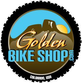 Logo of Golden Bike Shop, featuring stylized mountains and a sun, with the text "Golden Bike Shop" and ".com" in blue and gold letters, surrounded by a tire tread design. Location: Colorado, USA.