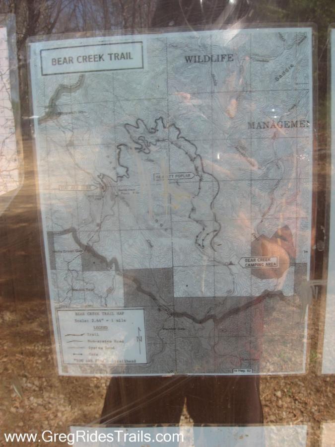 A map of Bear Creek Trail displaying topographic details, wildlife management areas, and camping sites. The map includes a legend indicating trails and other features, oriented with a north arrow. Bear Creek mountain bike trail.