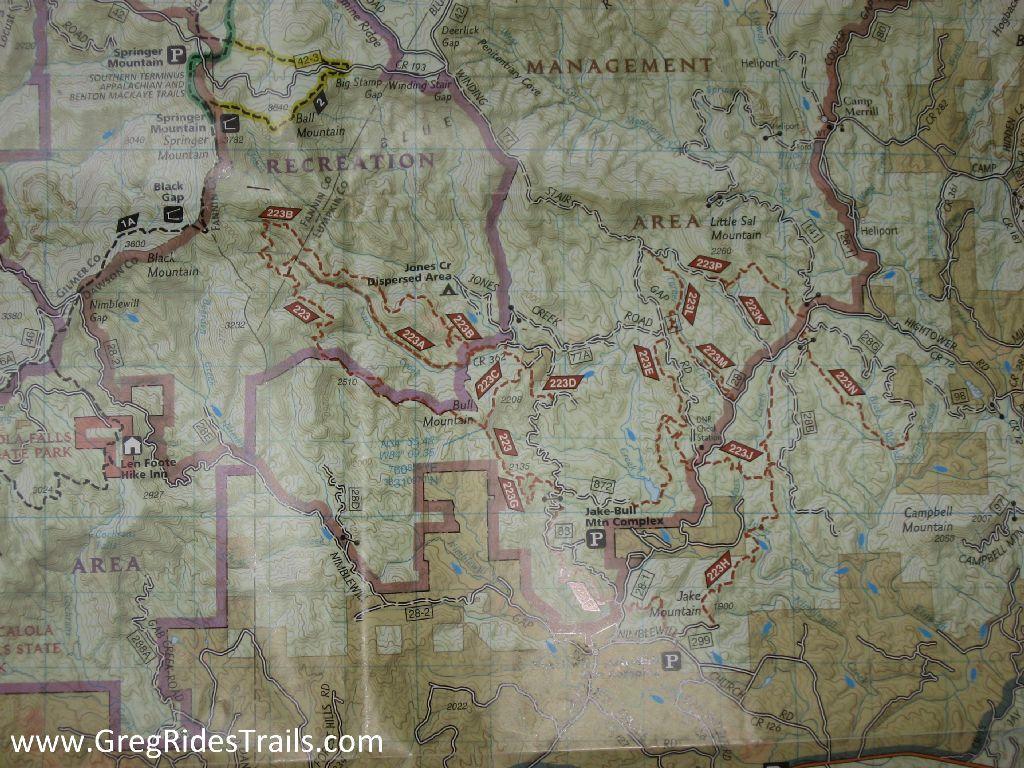 A detailed map depicting the topography and trails of a recreational area, marked with various features such as mountains, roads, and parking areas. The map includes labels for specific locations and recreational areas, with contour lines indicating elevation changes. Bull / Jake Mountain mountain bike trail.