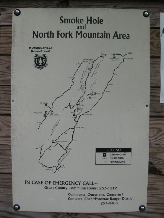 Map of the Smoke Hole and North Fork Mountain Area in Monongahela National Forest, showing hiking trails, campgrounds, and private land. Includes emergency contact information and a legend for map features. North Fork Mountain Trail mountain bike trail.