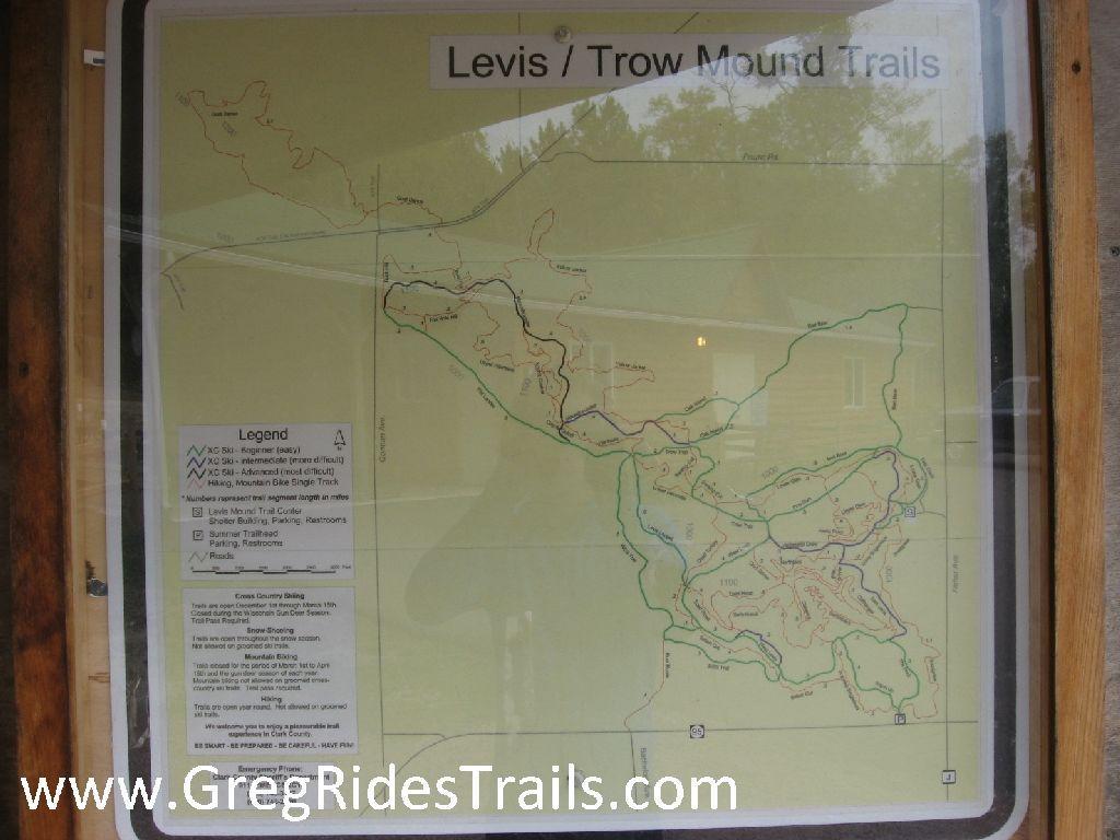 Map of the Levis/Trow Mound Trails, displaying various trail routes for hiking, mountain biking, and cross-country skiing. The map includes a legend indicating skill levels and features such as parking and restroom facilities. Levis Mounds mountain bike trail.