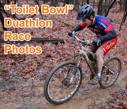 A cyclist navigating a muddy trail during the "Toilet Bowl" Duathlon race, showcasing determination and skill amidst wet and challenging conditions. The athlete is wearing a brightly colored jersey and protective gear while focused on the course ahead. Country Park mountain bike trail.