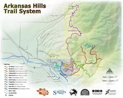 Map of the Arkansas Hills Trail System, showing various trails in different colors, terrain features, and landmarks. The map includes a legend to identify trail types and difficulty levels, along with logos of associated organizations. Arkansas Hills mountain bike trail.