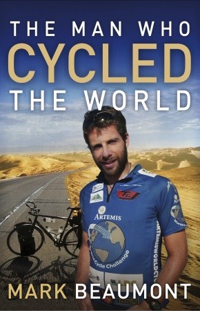 Book cover of "The Man Who Cycled the World" by Mark Beaumont, featuring an image of a man in a cycling jersey standing next to a bicycle on a road with a desert landscape in the background. The title and author's name are prominently displayed in bold text.