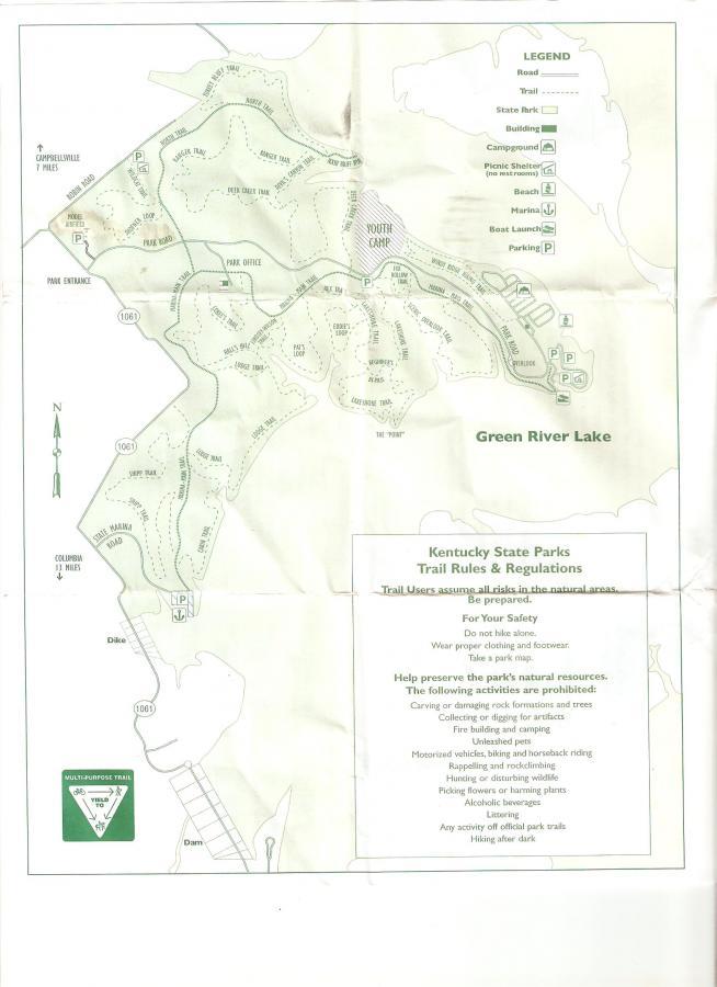 Map of Green River Lake State Park in Kentucky, showing the layout of trails, roads, buildings, campgrounds, picnic areas, and parking. The map includes a legend to identify different features and provides listed regulations and safety guidelines for park visitors. Green River mountain bike trail.
