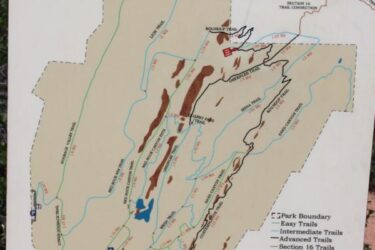 A detailed map of Red Rock Canyon Open Space, showing current trail access. The map includes labeled trails categorized as easy, intermediate, and advanced, along with park boundaries, trail distances, picnic areas, and points of interest. A north symbol is also present to indicate orientation. Red Rock Canyon mountain bike trail.
