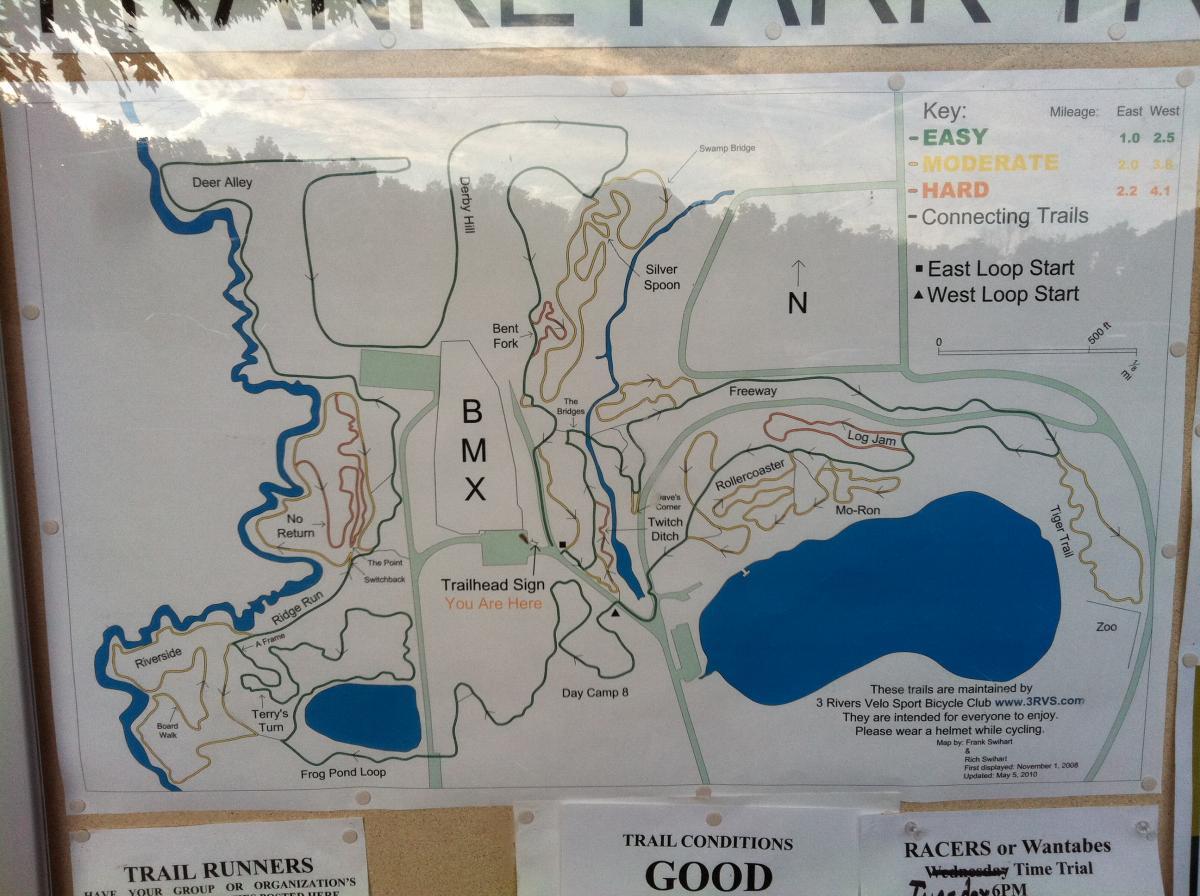 Map of a bike park featuring various trails categorized by difficulty levels: easy, moderate, and hard. The map includes highlighted paths such as BMX, Silver Spoon, and Freeway, along with connecting trails and a key indicating trail mileage. A marker shows "You Are Here" at the trailhead sign, with labels for surrounding landmarks like Frog Pond Loop and Day Camp 8. The bottom section displays trail conditions as "GOOD" and provides additional information for trail runners and safety reminders. Franke Park mountain bike trail.