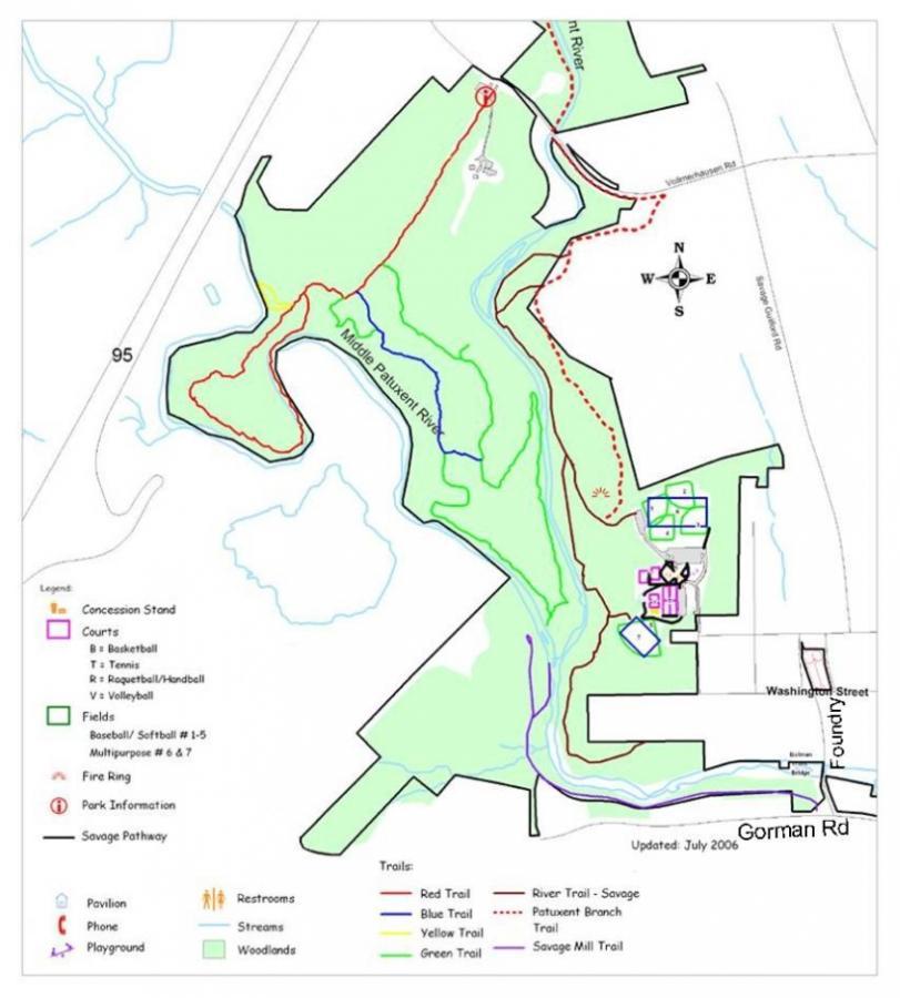 Map of a park area showing trails, fields, courts, restrooms, and park amenities. The map is color-coded to indicate different types of trails (red, blue, yellow, and green) and includes key landmarks such as a concession stand, playground, and picnic pavilion. It also outlines the Middle Pauxetn River and surrounding woodlands. North is indicated at the top of the map. Wincopin (Savage) Trail mountain bike trail.