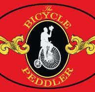 Logo for "The Bicycle Peddler," featuring a silhouette of a man on a vintage bicycle against a red background, with elegant gold accents and decorative elements.