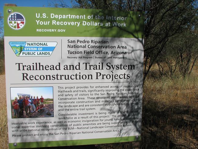 Sign detailing the trailhead and trail system reconstruction projects at San Pedro Riparian National Conservation Area in Arizona. The sign highlights the project's goals to enhance recreational access, improve visitor safety, and integrate construction with the natural landscape. It includes information about the funding and collaborative efforts involved in the project. San Pedro Riparian National Conservation Area mountain bike trail.