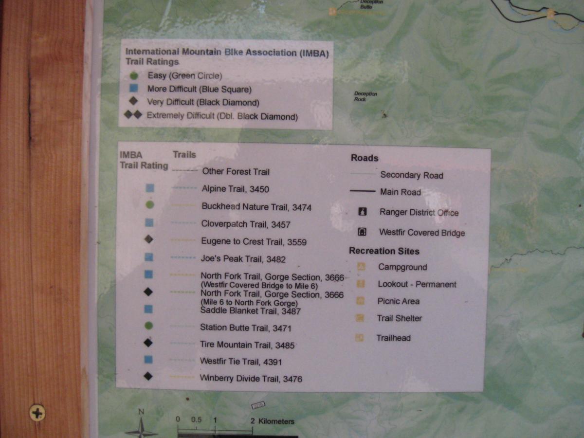 Map of mountain bike trails and ratings by the International Mountain Bike Association (IMBA). The map displays various trails with their difficulty levels indicated by colored circles and diamonds: easy (green circle), more difficult (blue square), very difficult (black diamond), and extremely difficult (double black diamond). It also includes marked roads, recreation sites, and locations such as campgrounds and trailheads. Alpine Trail mountain bike trail.