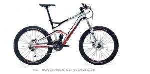 Cannondale Jekyll 3: Mountain bike with a black, white, and red color scheme, featuring a lightweight frame, front suspension, and disc brakes. The bike is displayed from the side, highlighting its design and components.
