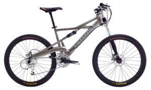 Cannondale Prophet 4: A silver mountain bike with a lightweight frame, front suspension, and large knobby tires, positioned on a white background.
