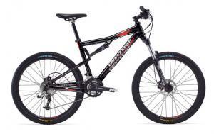 Cannondale Rize 5: Mountain bike featuring a black frame with red and silver accents, equipped with disc brakes and thick, rugged tires suitable for off-road terrain.