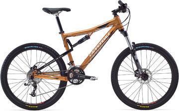 Cannondale Rize 5: A modern mountain bike with an orange and black frame, featuring front and rear disc brakes, thick tires, and a suspension system designed for off-road riding.