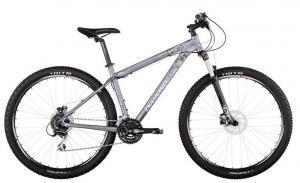Diamondback Overdrive Comp: A silver mountain bike with thick tires, a sturdy frame, and a front suspension fork. The bike features a standard seat and handlebars, designed for off-road cycling.