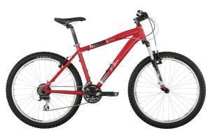 A red mountain bike with thick, knobby tires, a sturdy frame, and front suspension, positioned against a plain background.