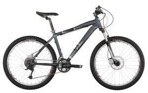 Diamondback Response Comp: A gray mountain bike with wide tires, a sturdy frame, and disc brakes, positioned against a plain background.