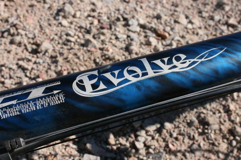 Ellsworth Evolve: A close-up image of a product labeled "Evolve," featuring a blue and black design. The focus is on the logo and text, with a rocky, textured surface in the background.