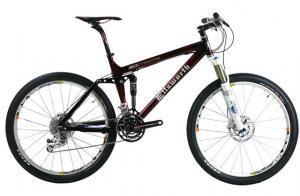 Ellsworth Truth: A high-quality mountain bike featuring a glossy maroon frame, front suspension, and disc brakes. The bike has knobby tires suitable for off-road terrain and is positioned at an angle against a white background.