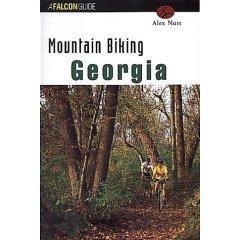 Falcon Guides Mountain Bike Georgia: Book cover for "Mountain Biking Georgia" by Alex Nutt, featuring a cyclist riding through a wooded area with trees and foliage. The title is prominently displayed at the top in bold, white text, with "Georgia" highlighted in larger, green font.