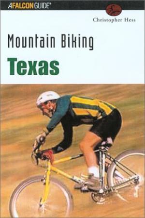 Falcon Guides Mountain Biking Texas: Book cover for "Mountain Biking Texas" by Christopher Hess, featuring a mountain biker riding a yellow and black bicycle on a grassy trail. The title is prominently displayed in green text at the top.
