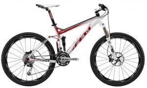 Felt Virtue 1: A modern mountain bike with a white and red frame, featuring front suspension, disc brakes, and wide tires, positioned on a clean background.