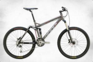 Felt Virtue Two: A grey mountain bike with thick, patterned tires, a sturdy frame, and a suspension system. The bike is shown against a plain white background.